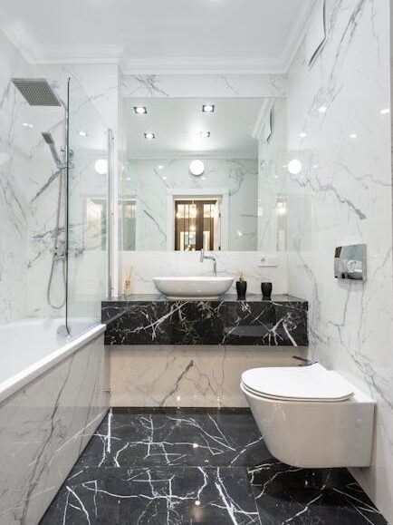 pexels-photo-6920611-6920611 Luxurious bathroom featuring marble walls and floor with modern fixtures and minimalist design. Done by a tile contractor