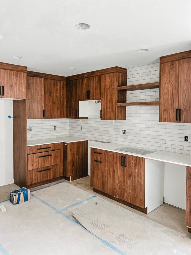 White subway kitchen tile backsplash with wood cabinets