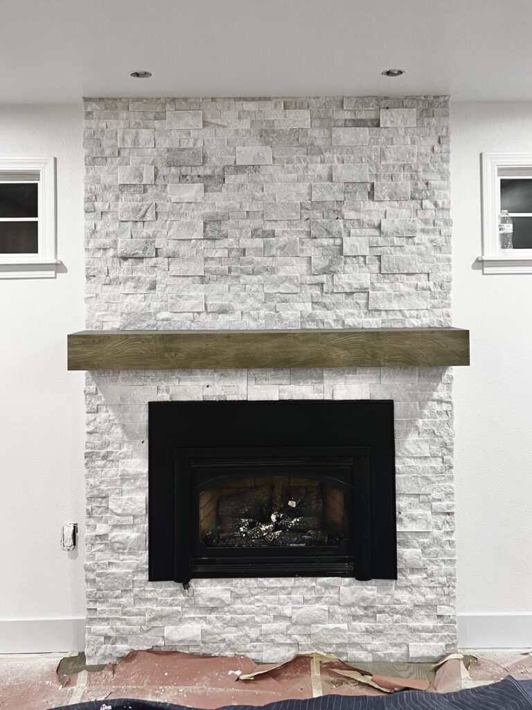 Floor-to-ceiling stone fireplace surround