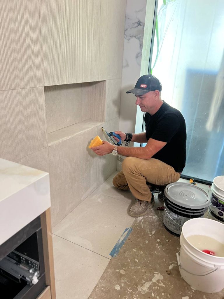 Andzhei installing bathroom tile