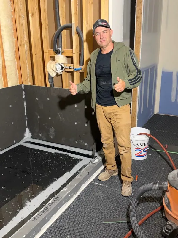 Andzhei on site during shower prep for tile