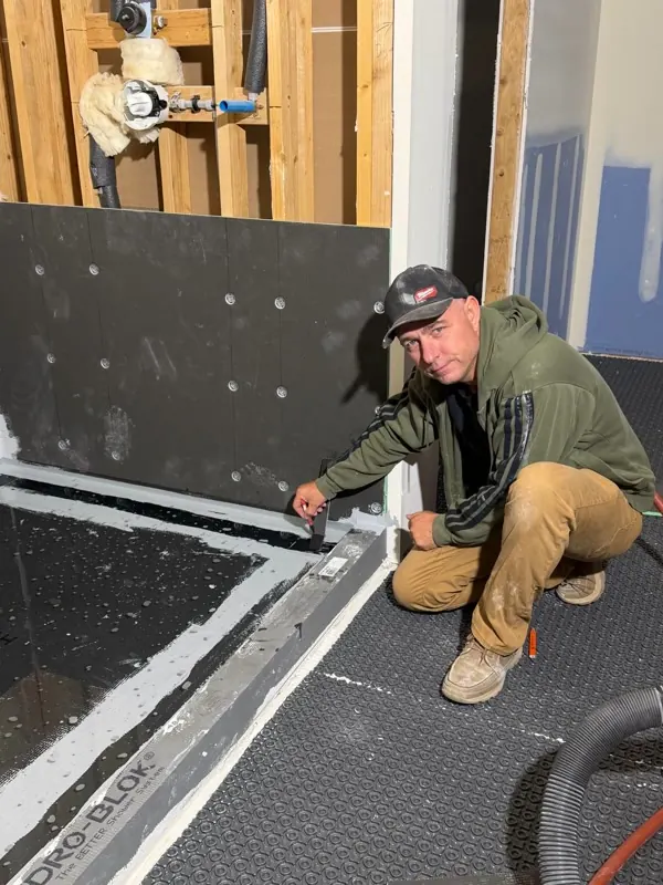 Andzhei waterproofing a shower corner before tile