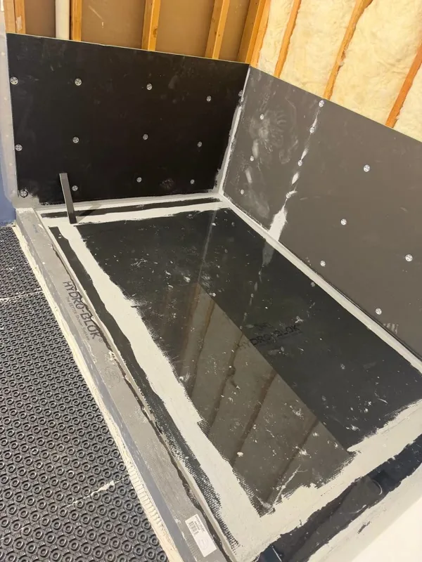 Shower pan and curb prepped for tile