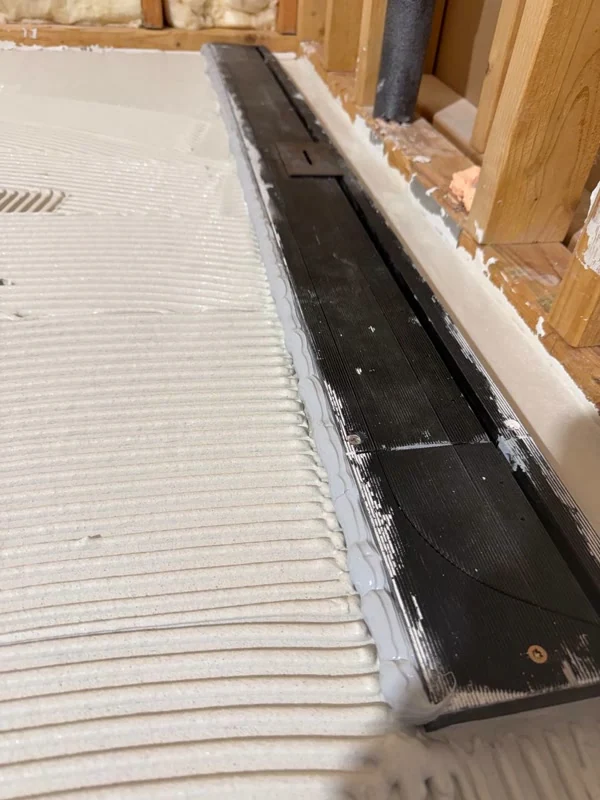 Linear shower drain set with thin-set floor preparation