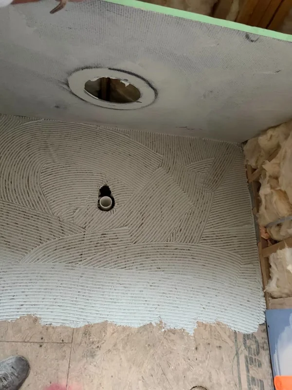 Thin-set on shower floor and wall board around drain opening