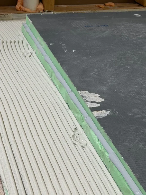 Foam-core shower pan board set into thin-set mortar