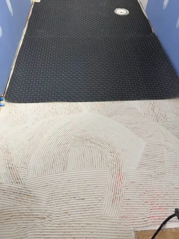 Notched thin-set ridges ready for floor membrane install
