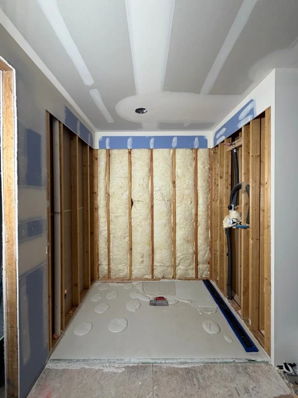 Walk-in shower rough-in with insulation and floor prep in a Shoreline ranch bath