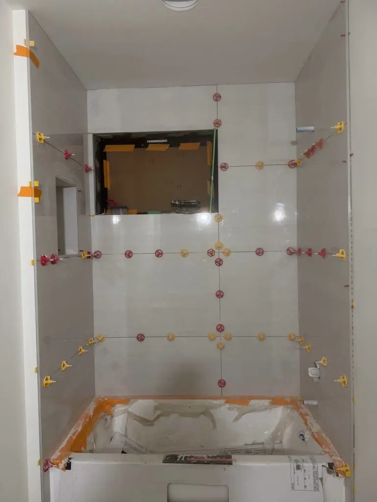 Walk-in shower tile walls during a remodel in Medina