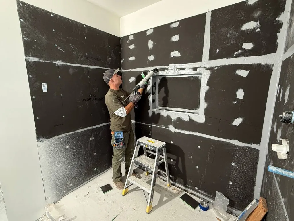 Bathroom remodel contractor Andzhei sealing Hydroblok shower walls before tile